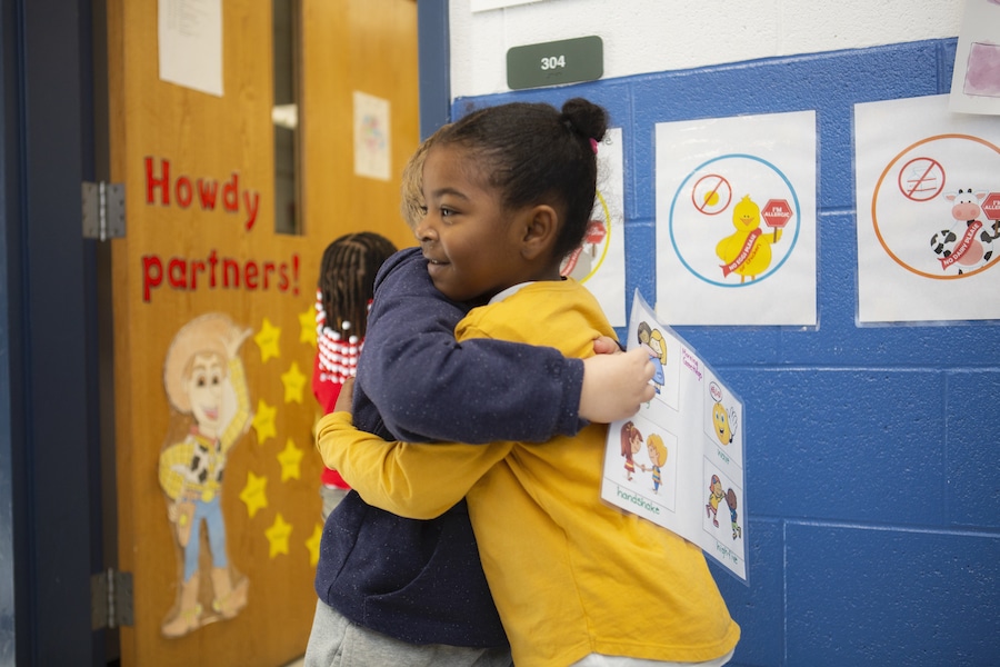 children hugging and smiling