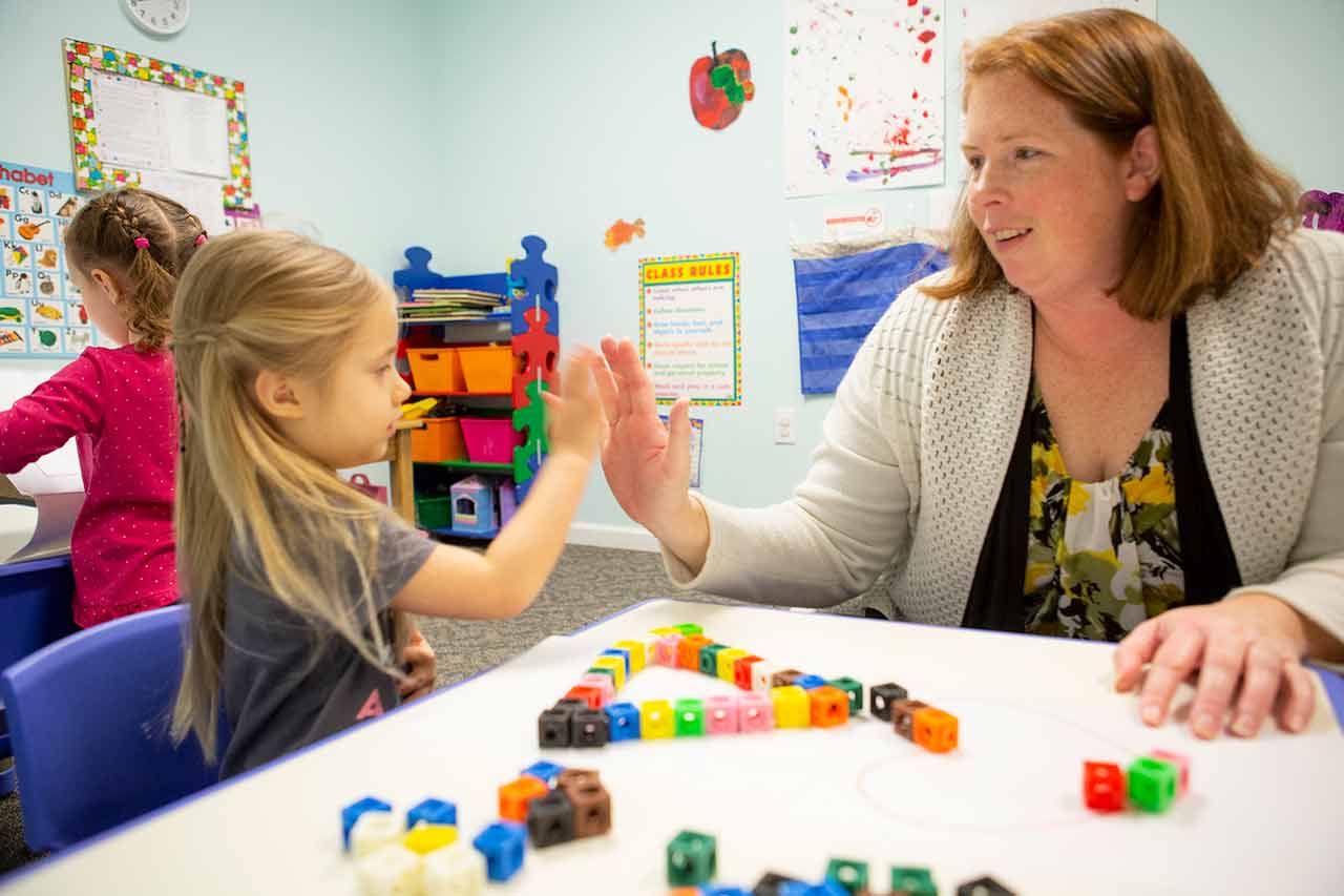 teacher and child giving high five