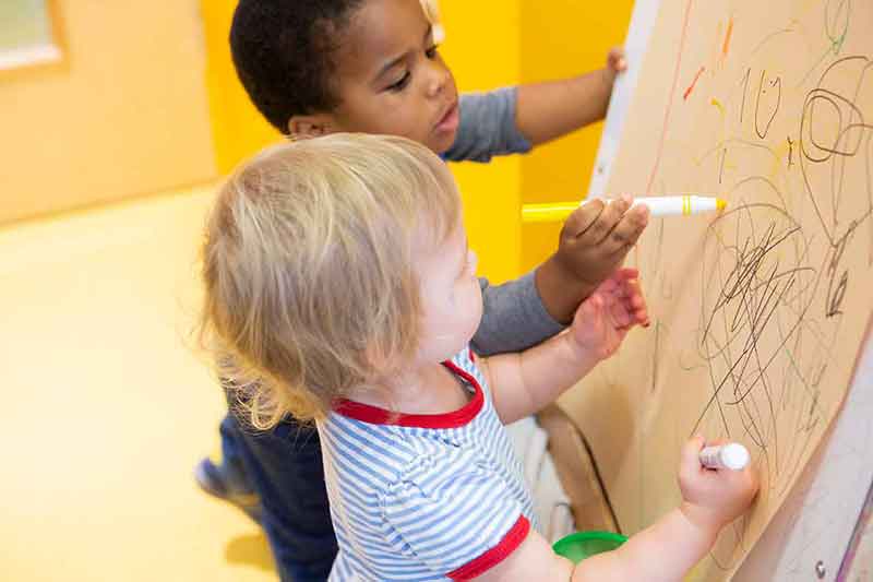 Two boys drawing together