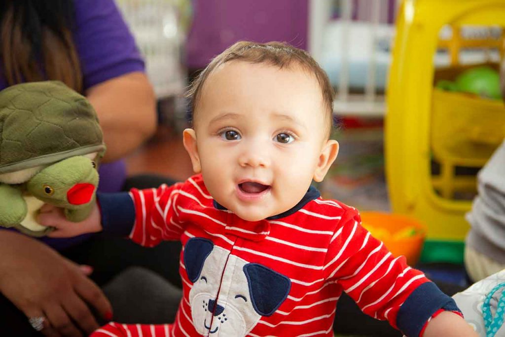 infant smiling at the camera