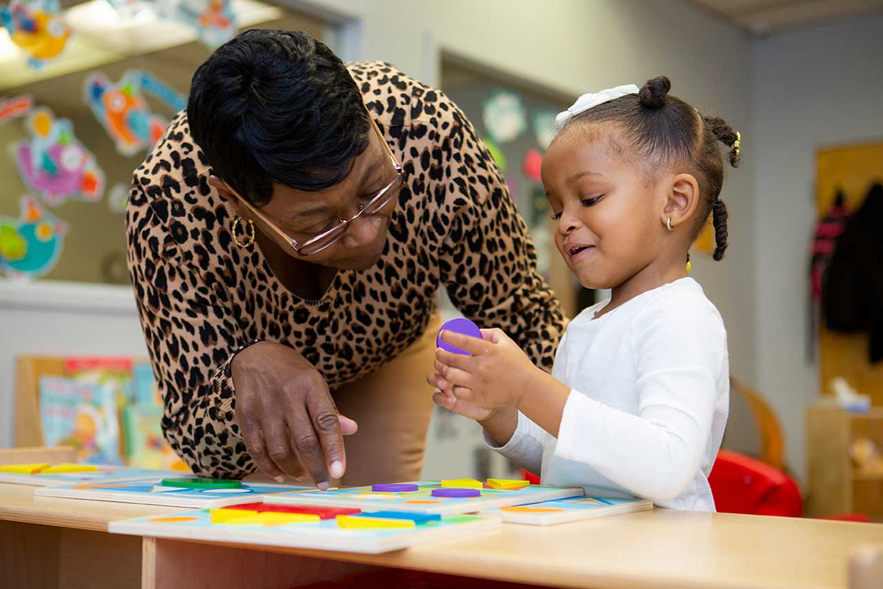 Teacher providing instruction in puzzle