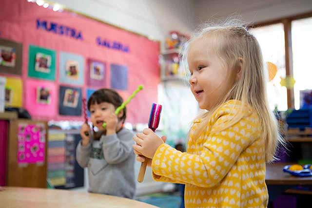 child following directions with musical toy